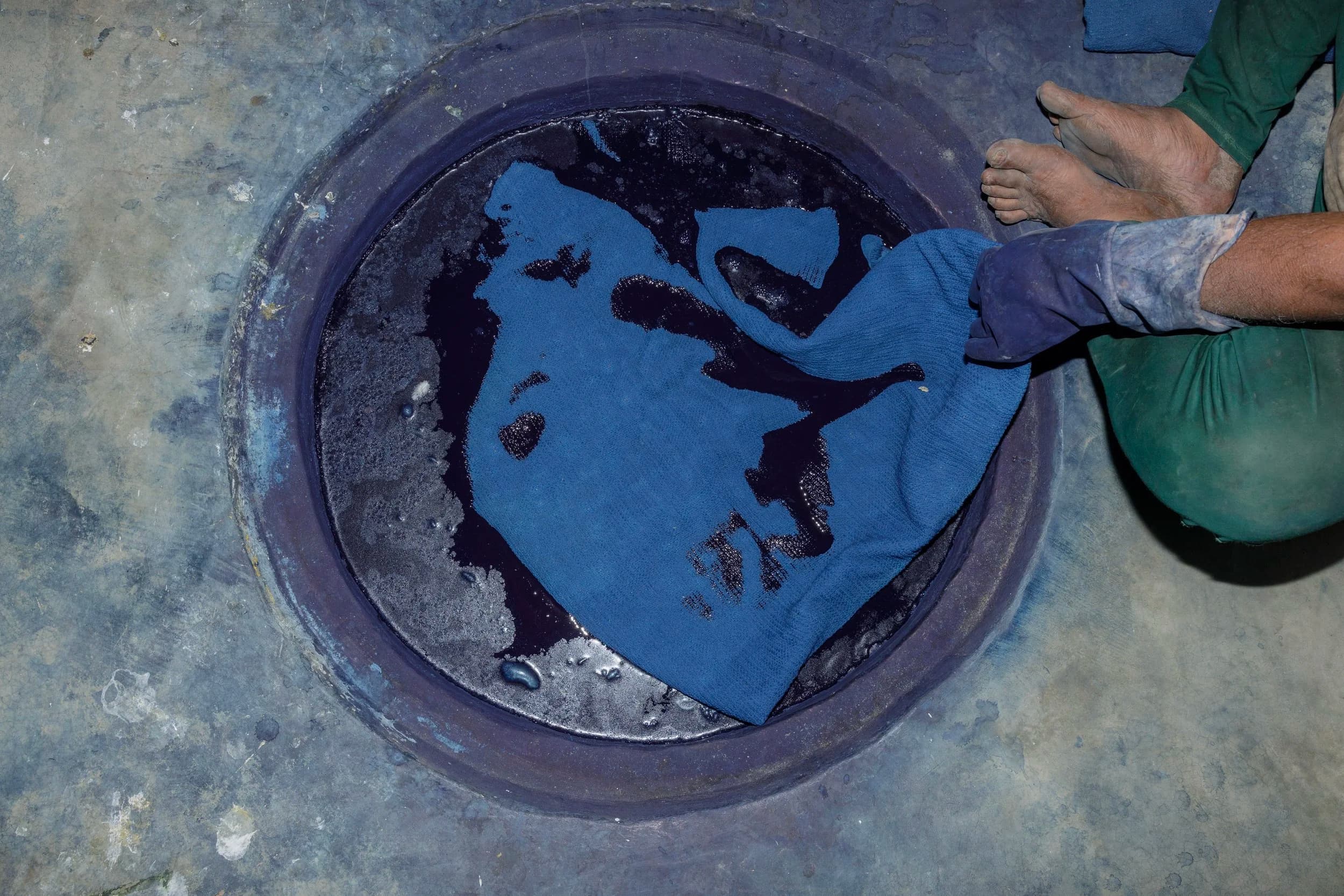 Indigo dye vat with blue fabric