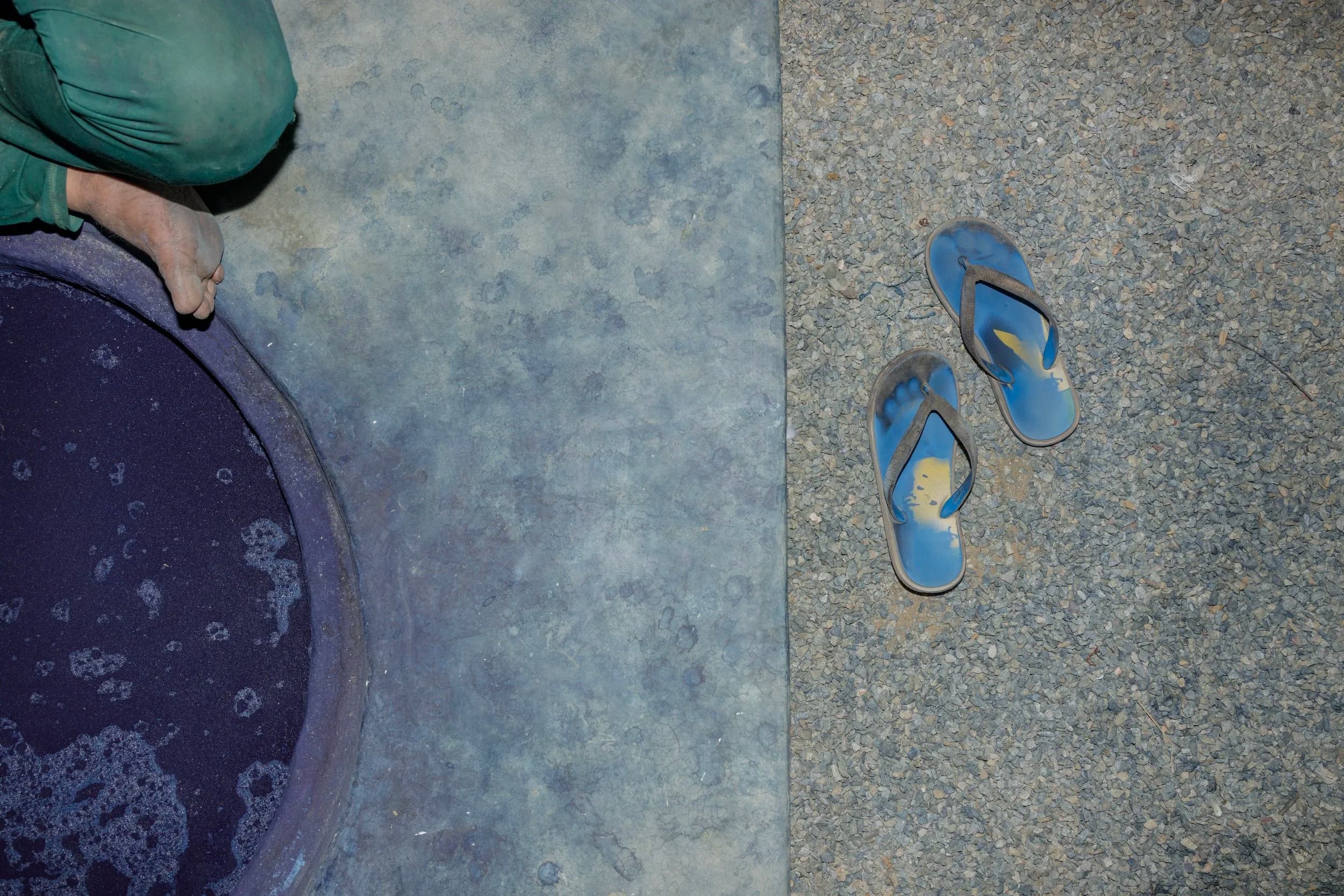 Artisan's feet by indigo dye vat