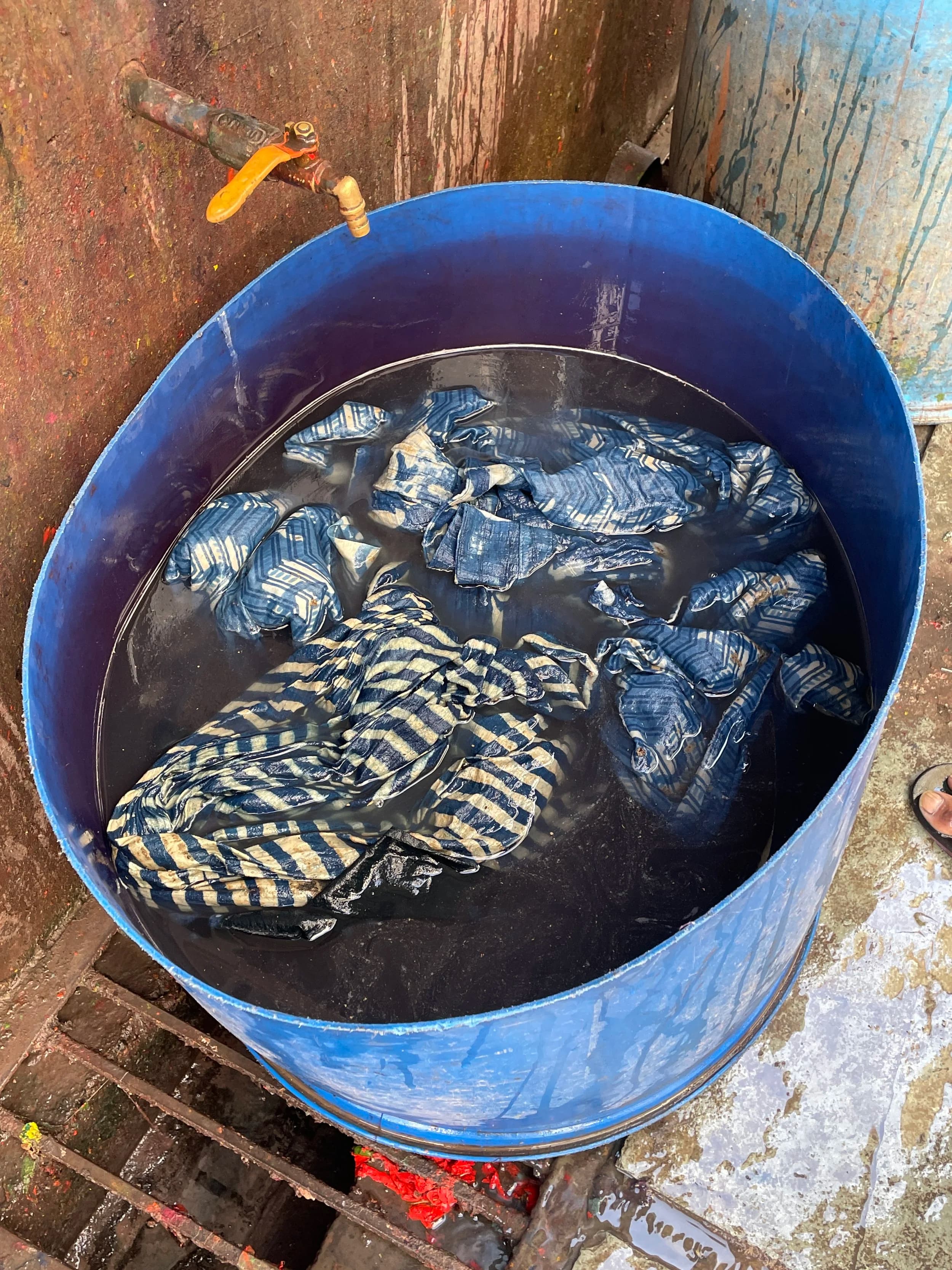 Fabric soaking in indigo dye vat